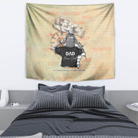 Gold-beige tapestry featuring father and son hugging with black “DAD” lettering