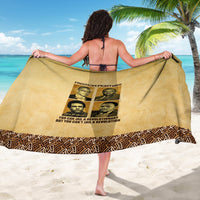 Beige sarong with Freedom Fighters graphic and patterned border, held open