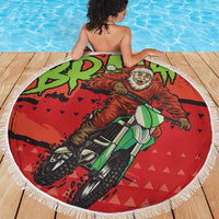 Red round beach blanket featuring Santa riding a motocross bike, white fringe edge, 150cm.