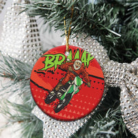 Red ceramic motocross Santa round ornament hanging on a Christmas tree