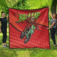 Red quilt blanket with black edge and motocross Santa illustration, worn drape view