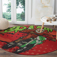 Red circular motocross Santa rug with green bike graphic and scattered triangle pattern