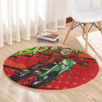 Red round area rug with Santa motocross rider on green bike, bold cartoon print