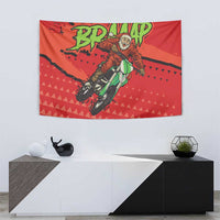 Red motocross Santa tapestry hanging on a wall with rider artwork and green text