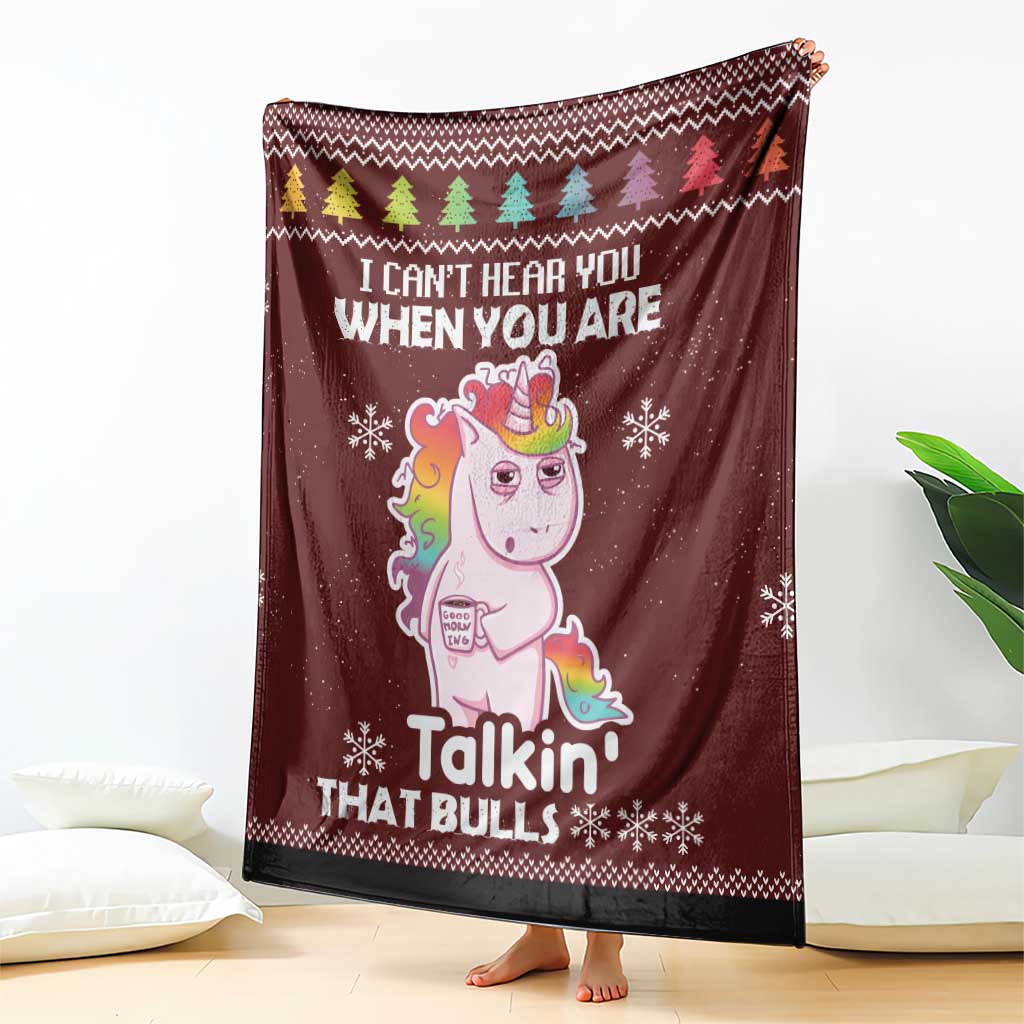 Burgundy unicorn Christmas blanket with front graphic, pine-tree row, and snowy flake pattern