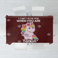 Christmas tablecloth, maroon with unicorn graphic and snowflakes, folded view