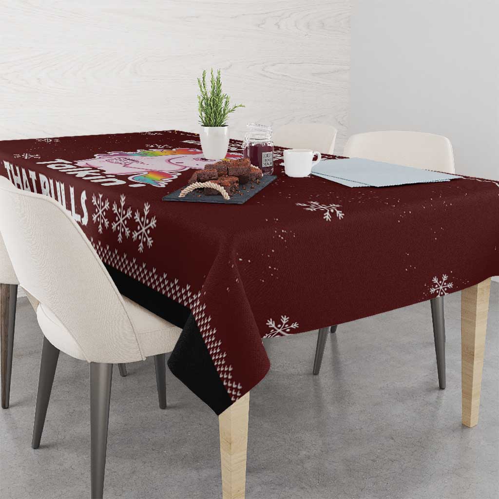 Christmas tablecloth, maroon with corner unicorn design and snowflake border, on table