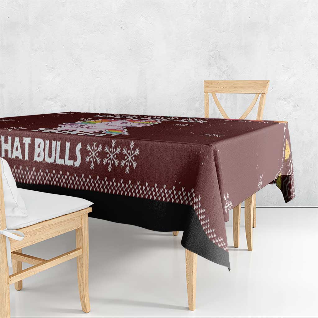Christmas tablecloth corner, maroon with bull text and snowflake print, draped on table