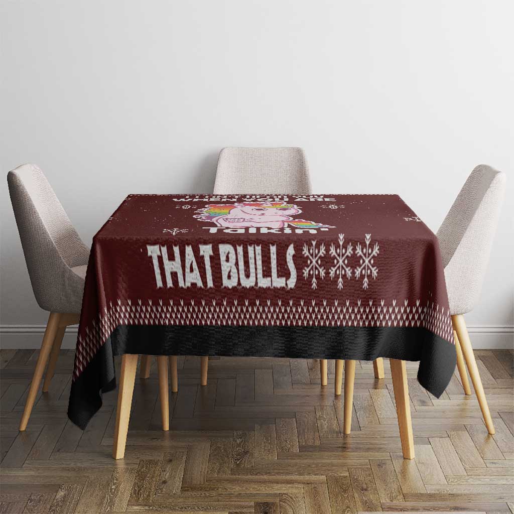 Christmas tablecloth, maroon with bull text and snowflakes, on square table with chairs