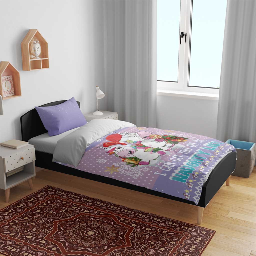 Light purple unicorn Christmas bedding set on bed with 'naughty list' graphic and gifts