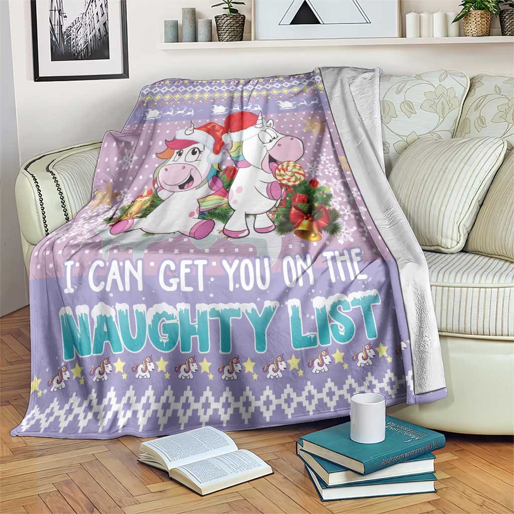 Light purple unicorn Christmas blanket draped over furniture, “naughty list” lettering
