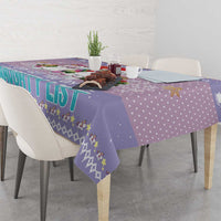 Light purple Christmas tablecloth draped on table with unicorns and dotted pattern