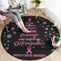Round black rug on floor with pink ribbon, snowflakes, and inspirational text
