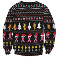 Black sweatshirt with all-over holiday pattern: trees, bells, snowflakes, pink ribbon accents