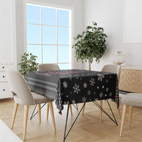 Black tablecloth with holiday snowflakes and pink ribbon awareness message