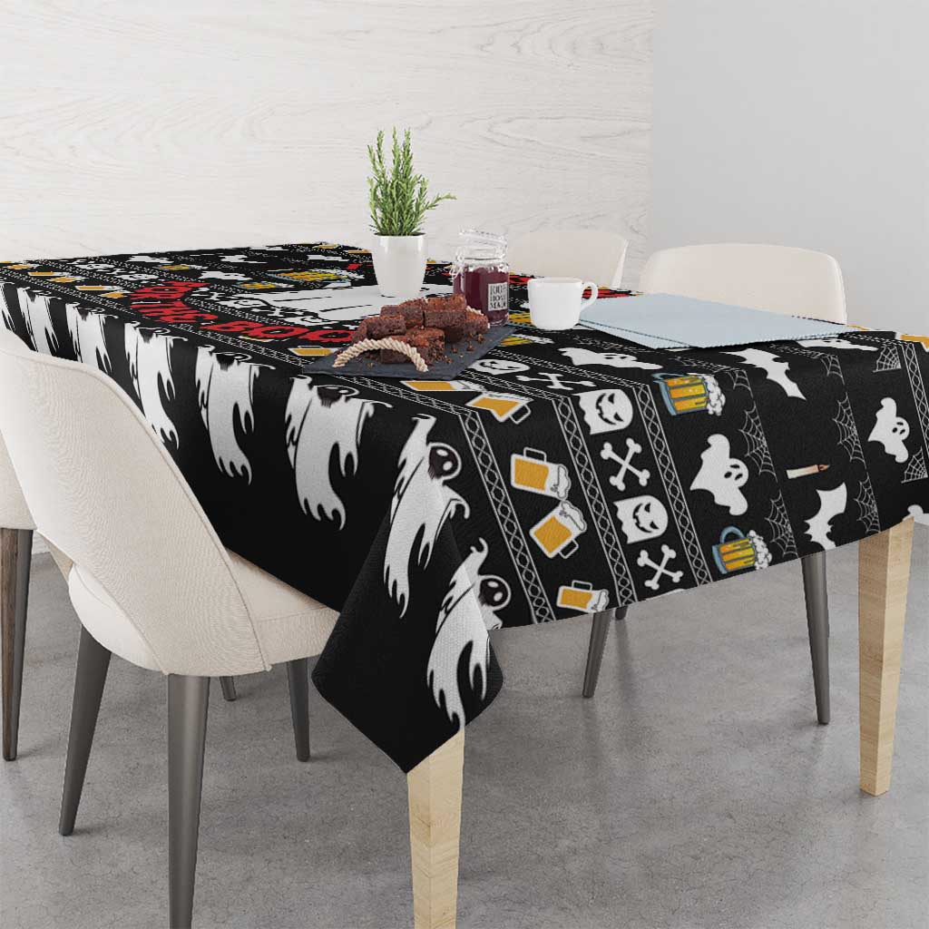 Black tablecloth with white ghost motifs and beer mugs, draped over dining table