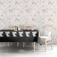 Black Halloween tablecloth with white ghost heads and beer mugs on dining table