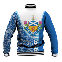 Blue unisex baseball jacket back with striped rib hem, swirly pattern, and crest