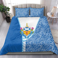 Blue bedding set with matching pillows, swirling pattern, and Scotland crest on white panel.