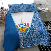 Blue duvet and pillow set with swirling swirls and Scotland crest on white center panel.