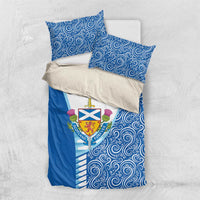 Blue bedding set with swirling pattern, Scotland crest on white center, and two pillowcases.