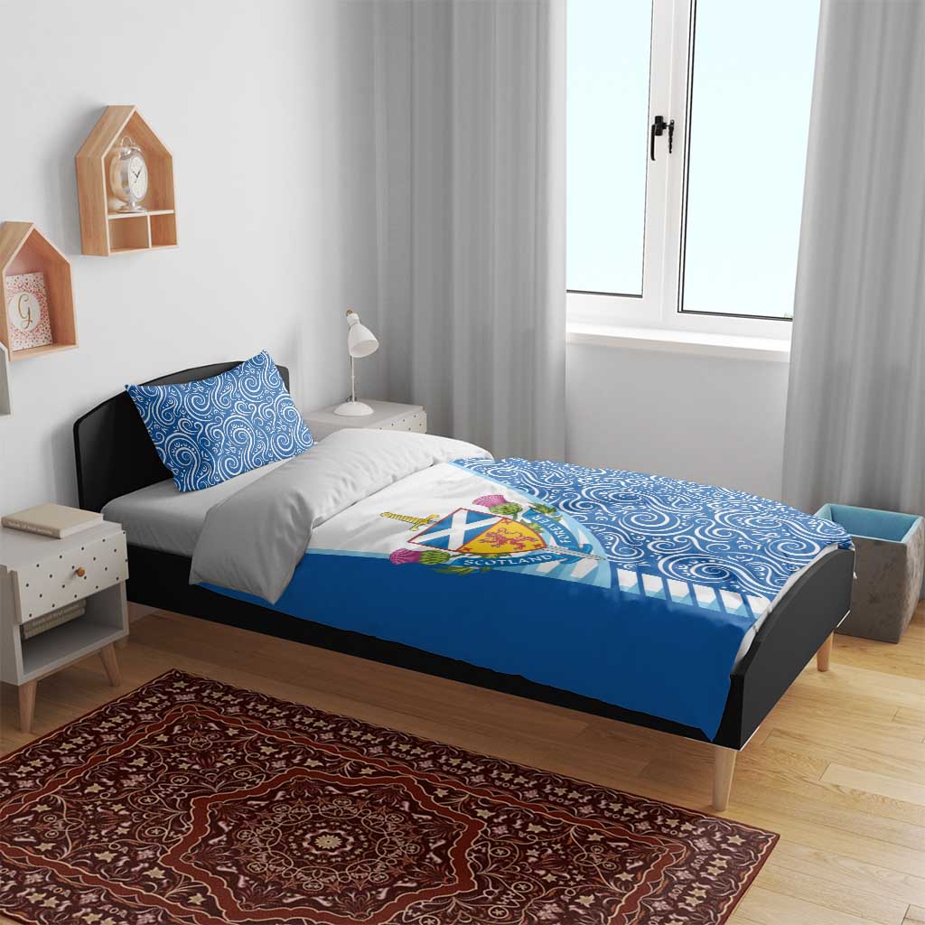 Blue bedding set with duvet featuring swirling pattern and Scotland crest on white panel.