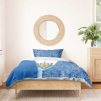 Blue duvet and pillow with swirling pattern and Scotland crest on white center panel.