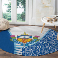 Circular blue rug with Scotland shield crest, thistle motifs, striped rays and swirls