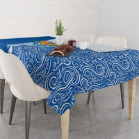 Blue swirl-pattern tablecloth covering the tabletop with matching overhang.