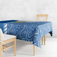 Blue swirling tablecloth with drop-edge drape over a bench seat.