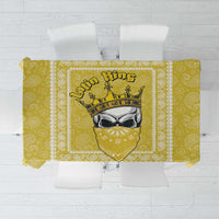Yellow paisley-pattern tablecloth with decorative banner print in the center.