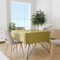 Yellow paisley-pattern tablecloth draped over a dining table.