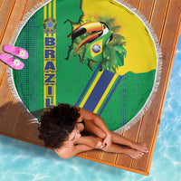 Round beach blanket with white fringe, green/yellow toucan and Brazil emblem; held flat