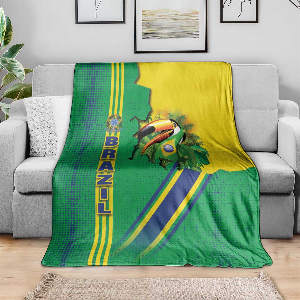 Green Brazil flag toucan emblem blanket spread on gray sofa, blue diagonal stripe design