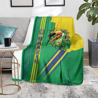 Green Brazil flag toucan blanket on light rug, yellow and blue striped pattern