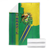 Green Brazil flag toucan emblem blanket with yellow/blue stripes, neatly stacked with towels