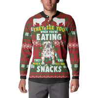 Red and green Christmas button sweatshirt worn by a man, featuring bulldog 'SNACKS' print