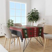 Red Christmas tablecloth with green snowflake and reindeer pattern on dining table