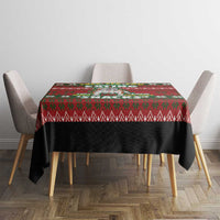 Red Christmas tablecloth with green patterned border and dark center on table