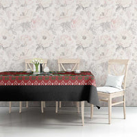 Red Christmas tablecloth with green festive pattern on rectangular dining table