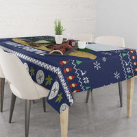 Navy tablecloth with pine and lantern motifs, festive border along the table edge