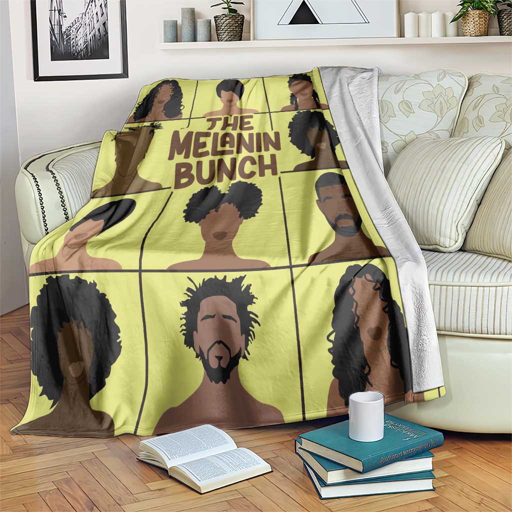Yellow printed blanket with black-and-brown portrait grid and 'THE MELANIN BUNCH' text