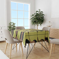 Yellow tablecloth with bold grid portraits of people in black and brown.
