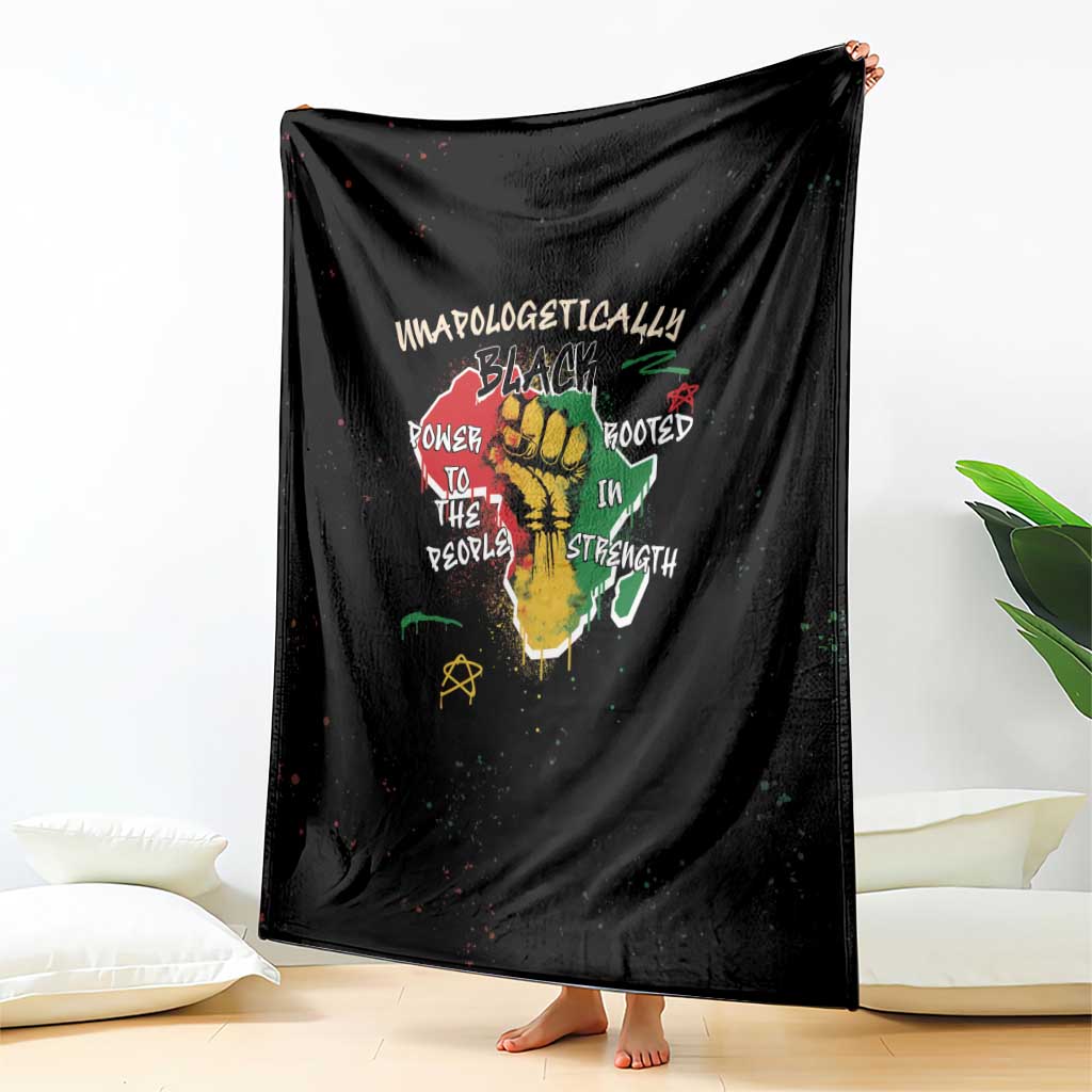 Black throw blanket with large centered typography and roots graphic