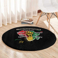 Black round carpet with colorful African text and lion-and-hand symbol