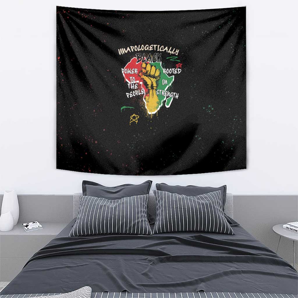 Black wall tapestry with centered hand-and-roots art and “unapologetically black” text