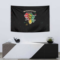 Black wall tapestry featuring a hand-and-roots graphic with multicolor quote text