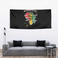 Black wall tapestry showing hand-and-roots graphic with vibrant quote text