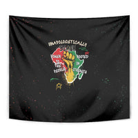 Black wall tapestry close-up of hand-and-roots graphic with multicolor words
