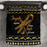 Black bedding set with gold dragonfly and “When Angels are near” text, patterned borders